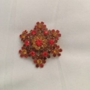 Orange and gold broach
